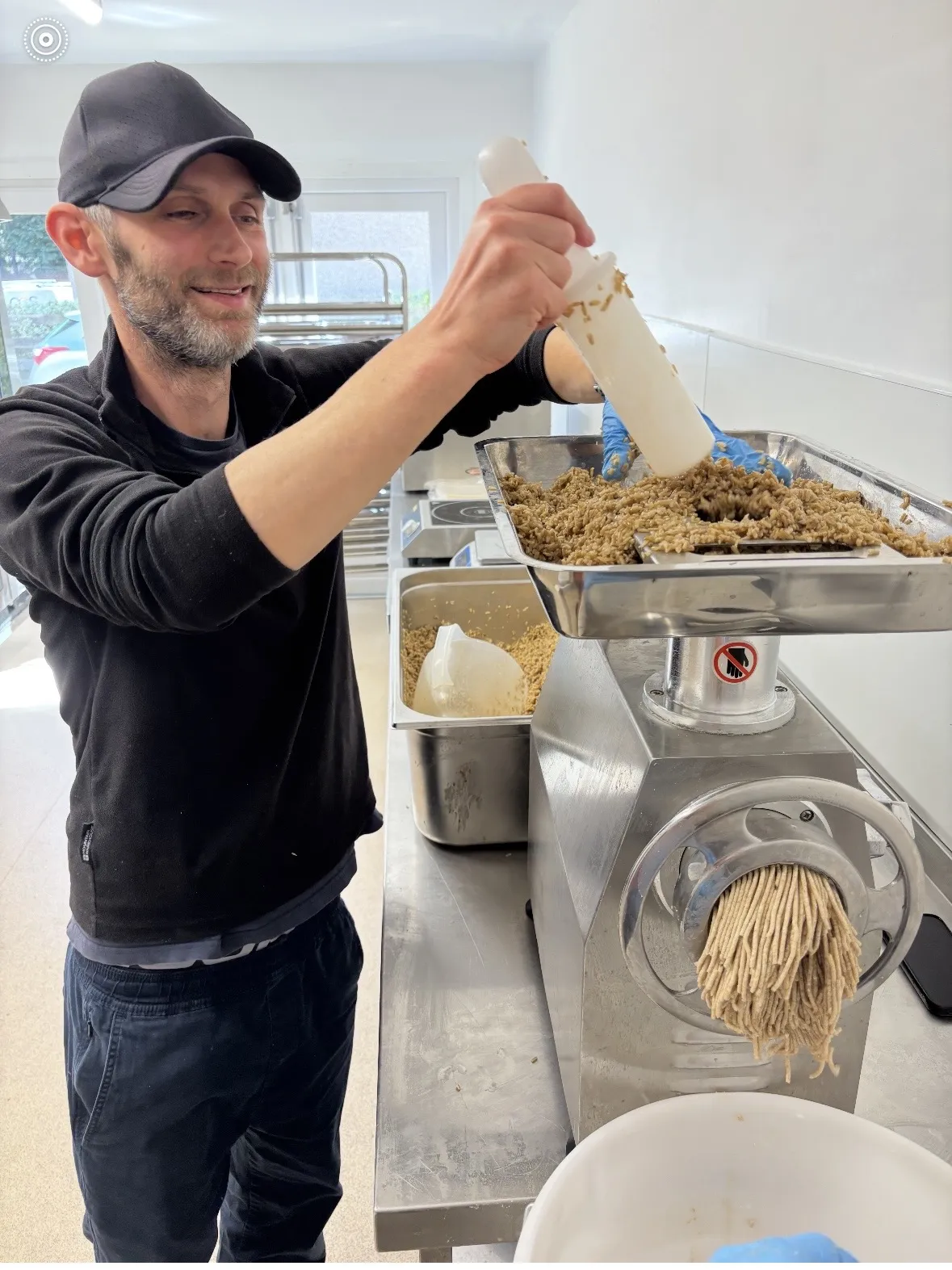 Chef Tim using a mincer to prepare ingredients